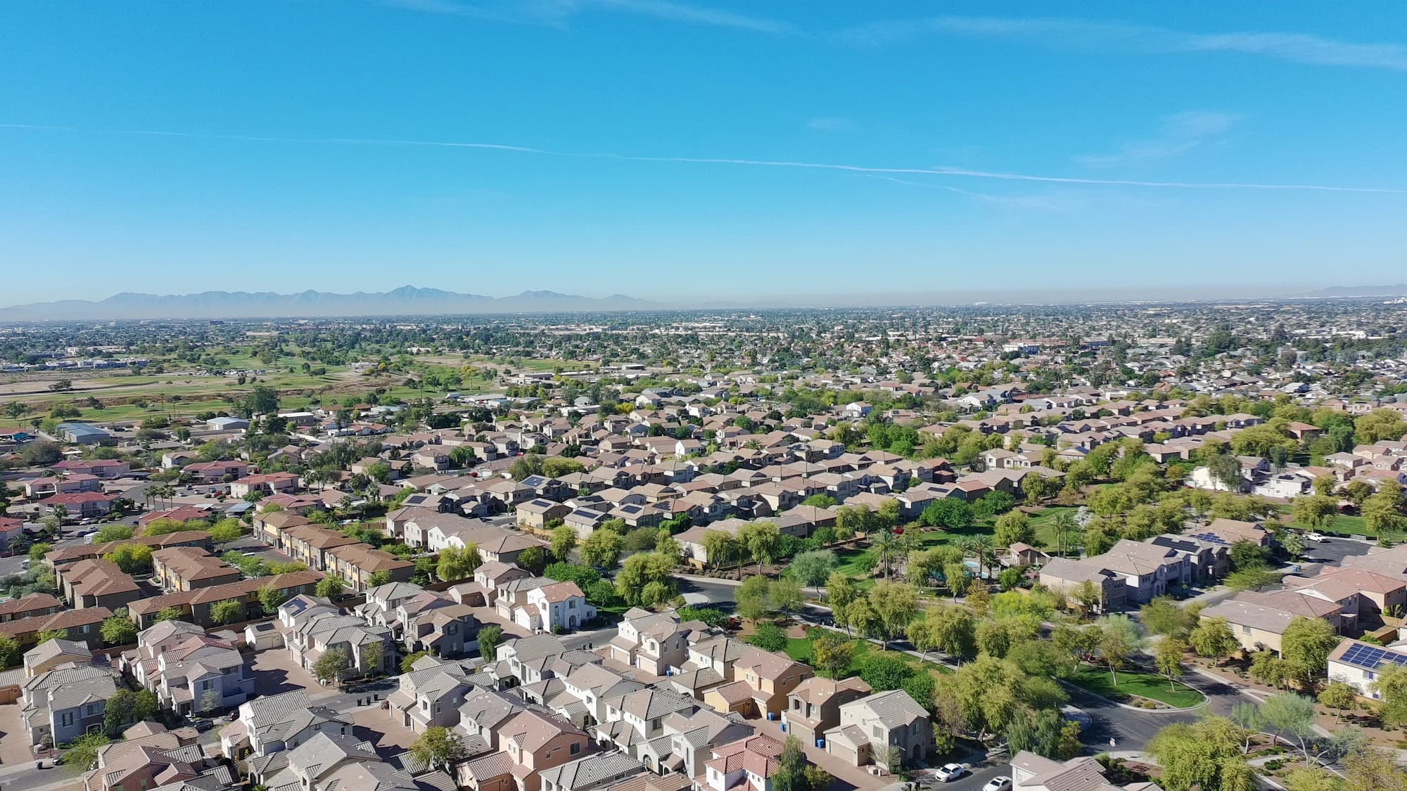 Vista aérea de un barrio residencial de Phoenix, Arizona, con casas de estuco y techos de teja